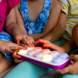 Children playing with a colorful light-up toy