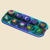 A colorful educational toy decorated with various celestial and nature illustrations, resting on a matching illustrated blue and green base against a solid beige background.