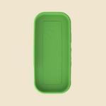 A green rectangular silicone mold or tray with rounded corners and embossed circular patterns, shown from a top-down view on a light beige background.