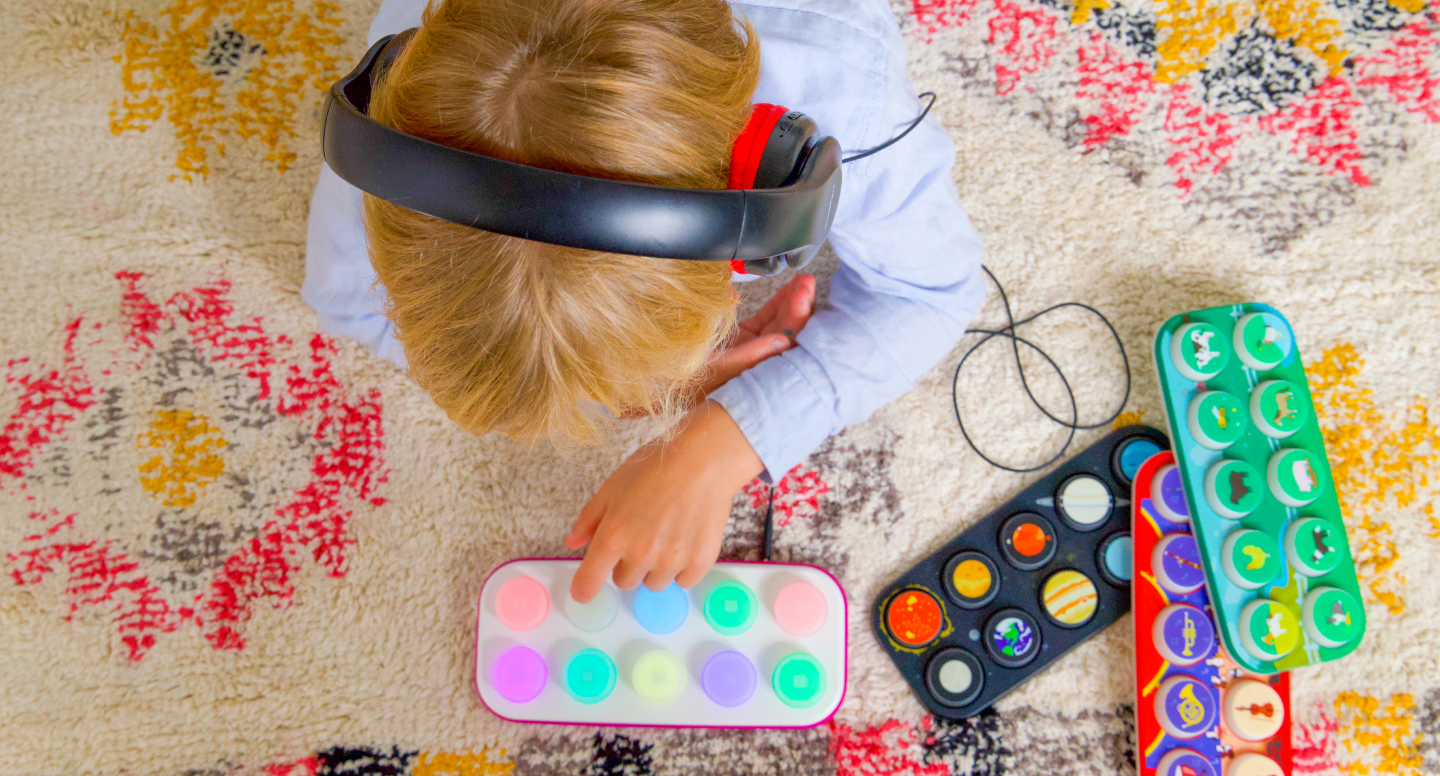 Child playing with colorful toys on a patterned rug
