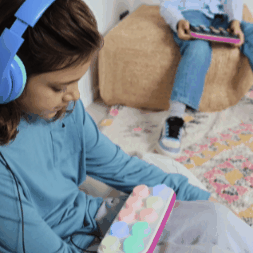 Girl listening to a story with headphones on Boppo